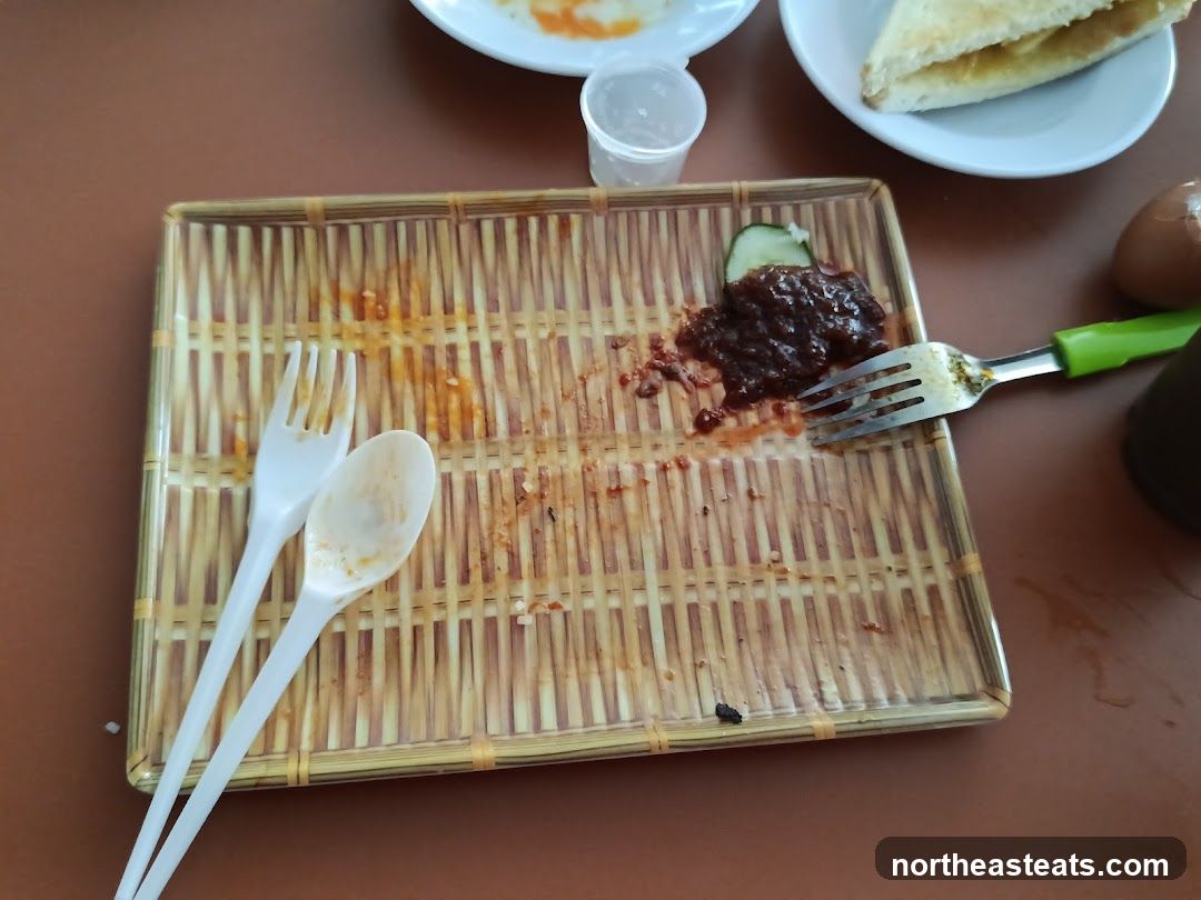 Dirty Tray with Utensils and Leftover Food