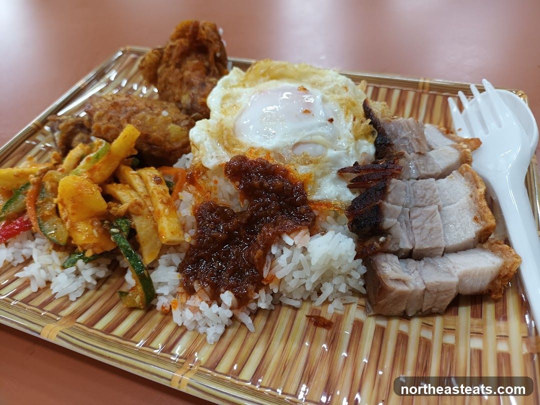 Rice dish with roasted pork and fried chicken