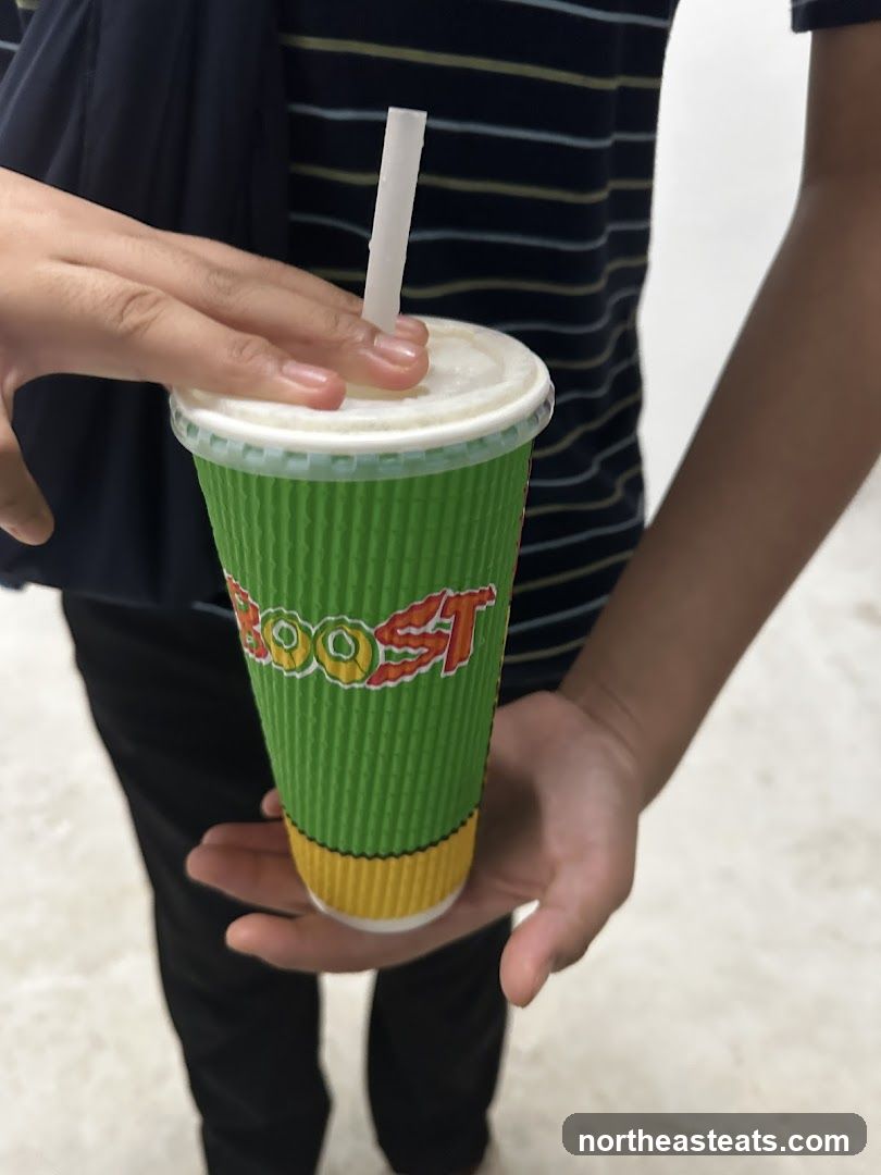 Person holding a Boost juice cup