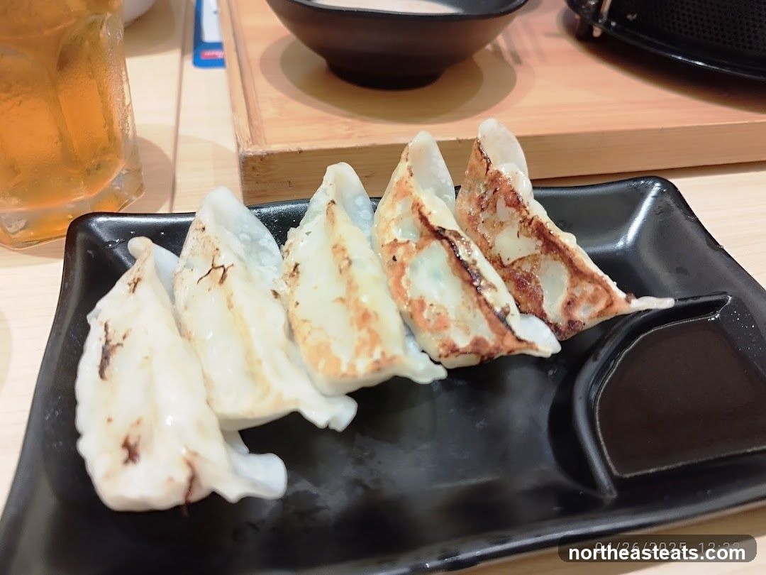 Pan-fried dumplings with dipping sauce