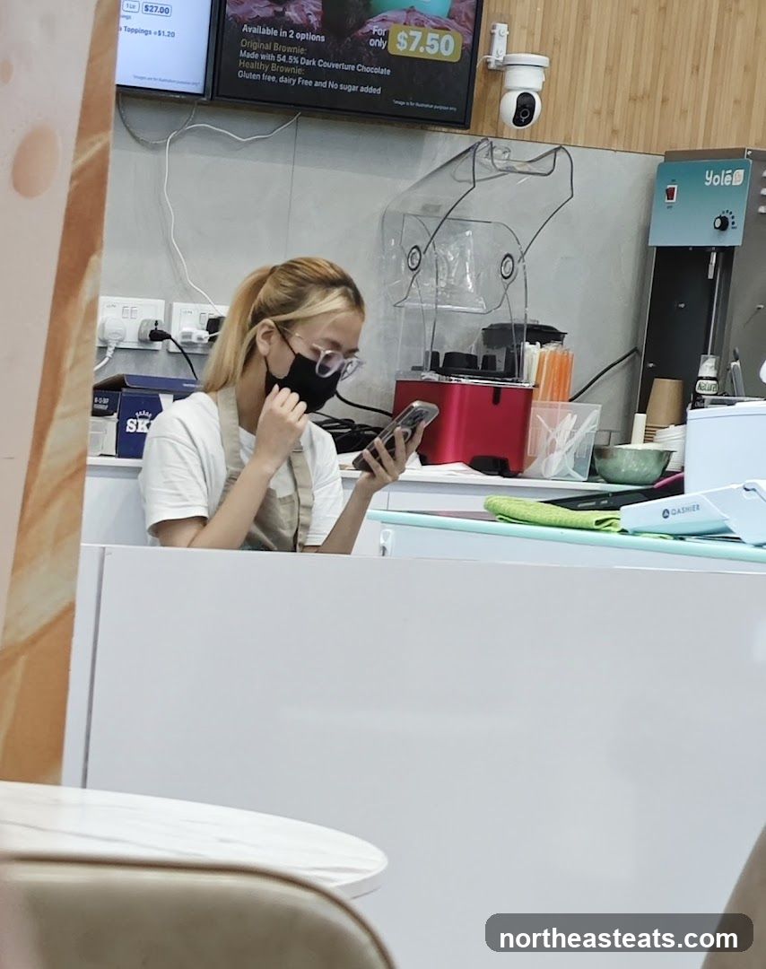 Staff member at a dessert counter