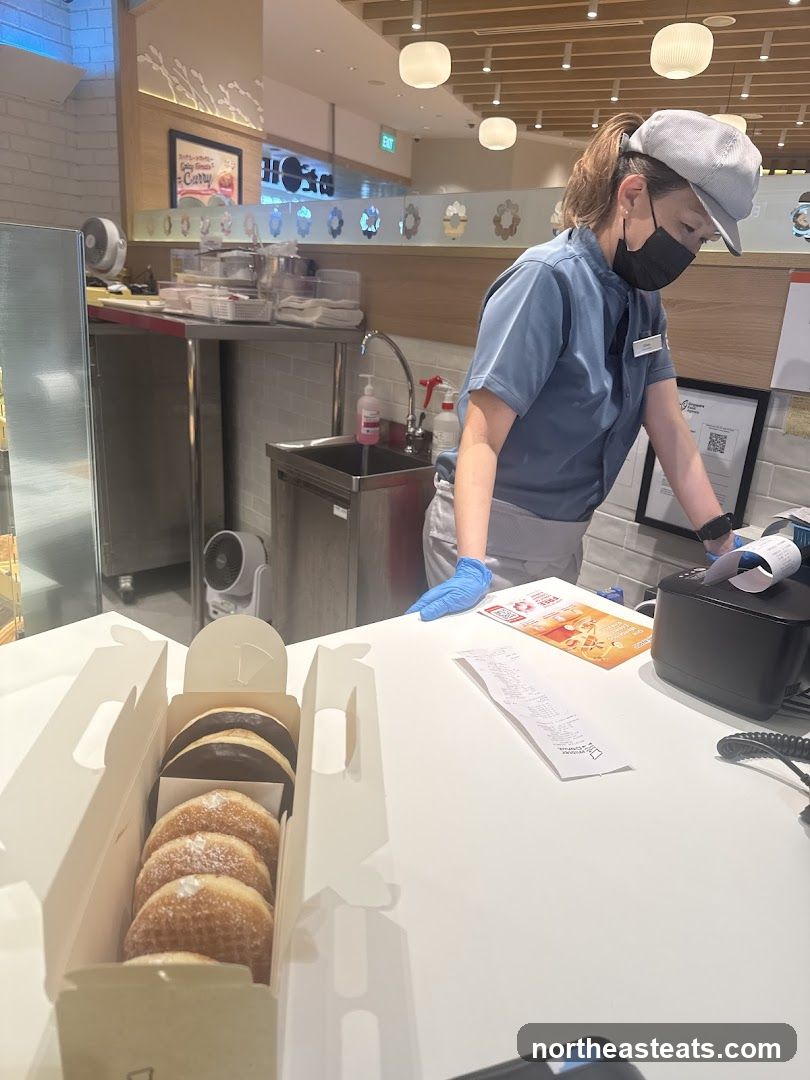 Donuts being prepared at a counter