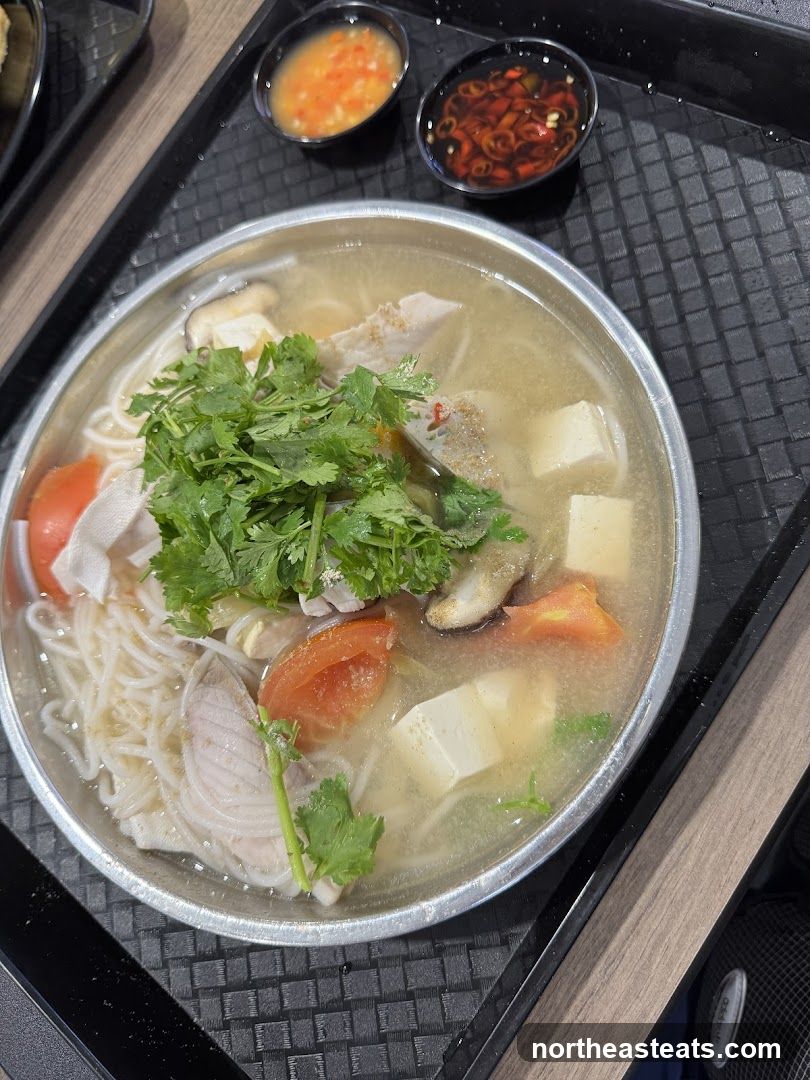 Fish noodle soup with tofu and tomatoes