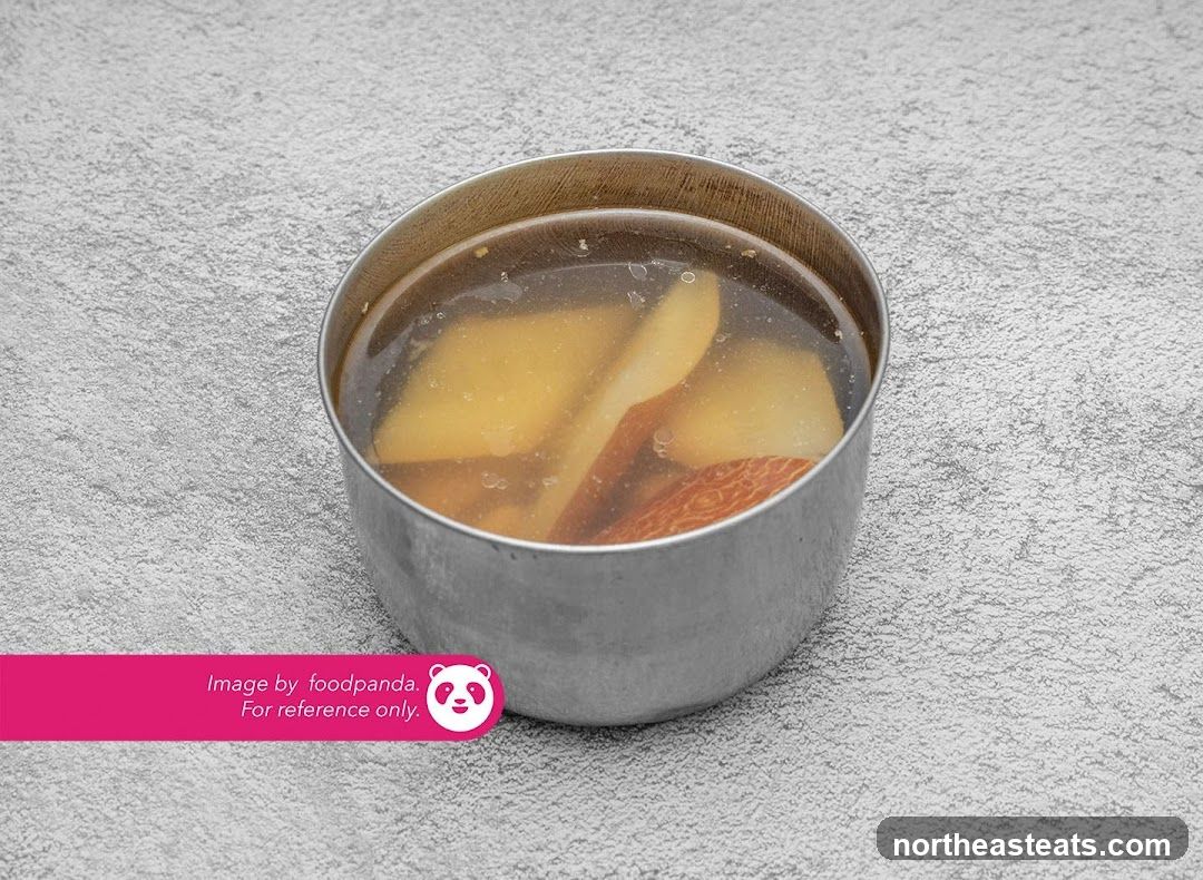 Bowl of soup with fruit slices