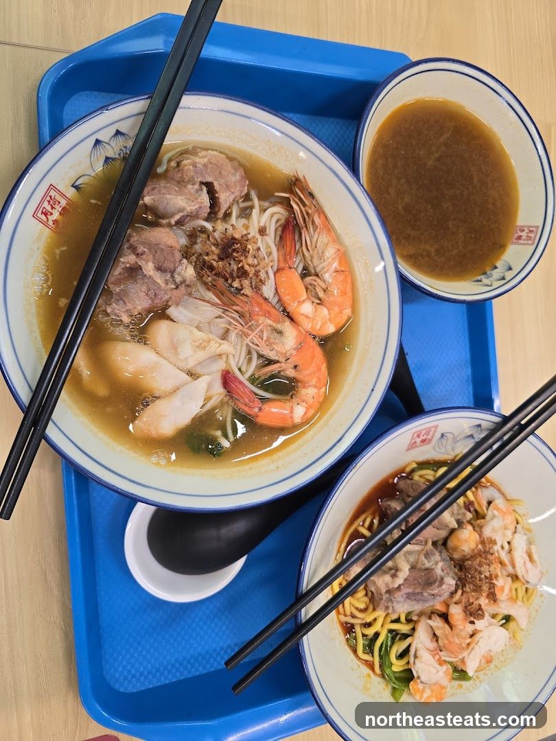 Two bowls of noodles with shrimp and meat