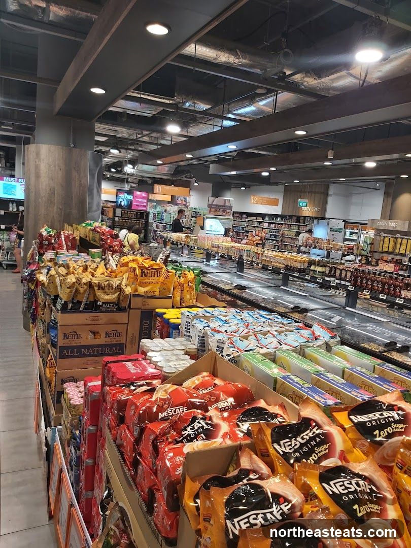 Supermarket aisle with coffee and snacks