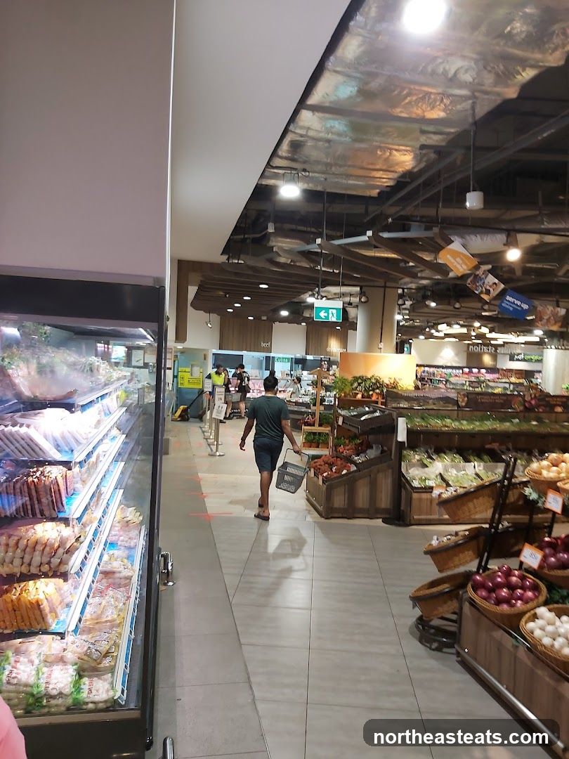 Supermarket aisle with produce and refrigerated goods