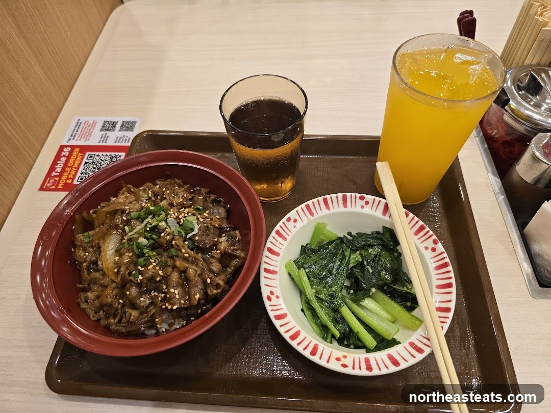 Beef bowl with side of greens and drinks