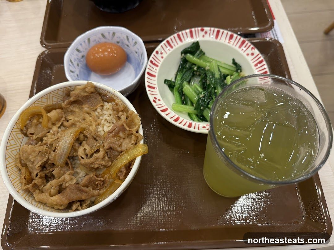Beef bowl with side dishes and drink