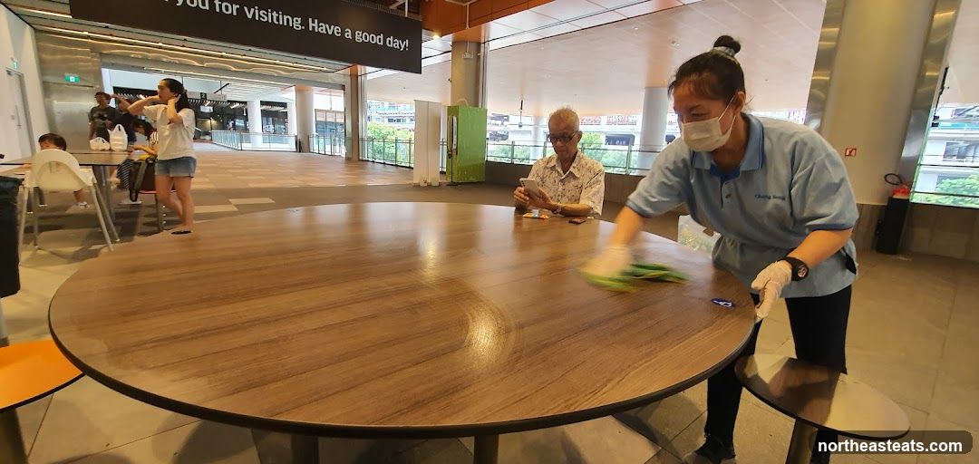 Cleaning staff wiping a table