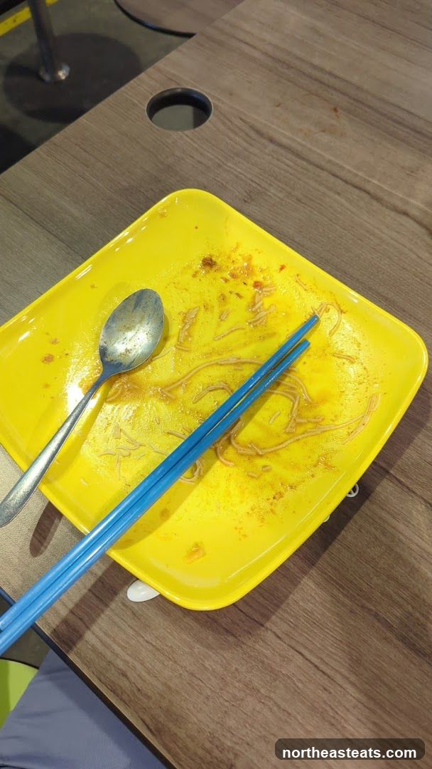 Dirty Plate with Noodles and Utensils