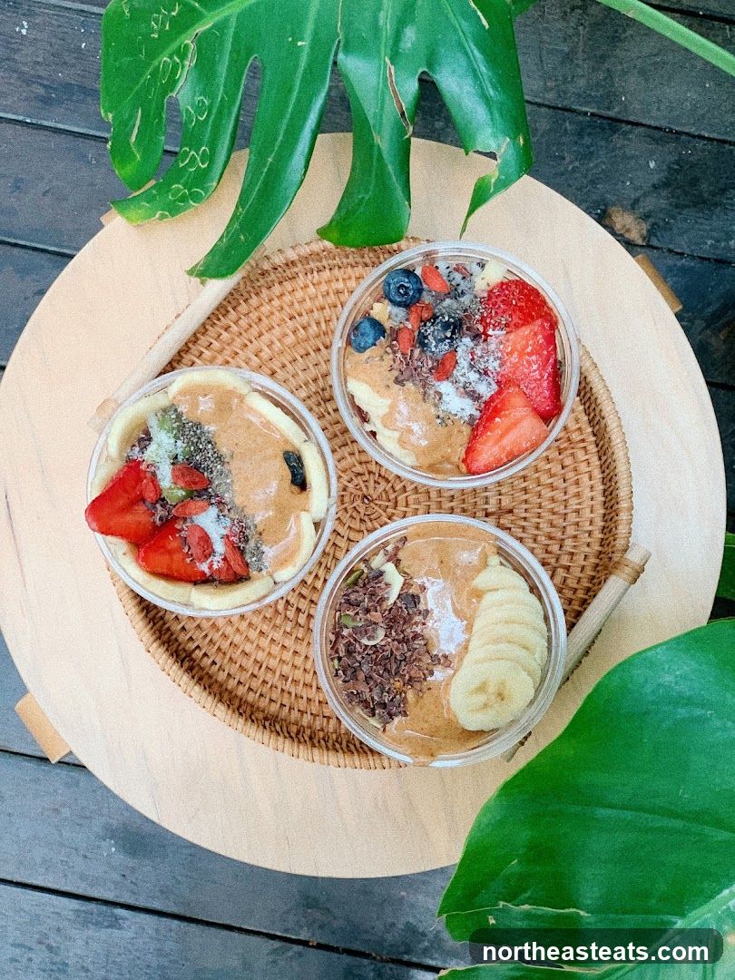 Three smoothie bowls with fruit and nut butter