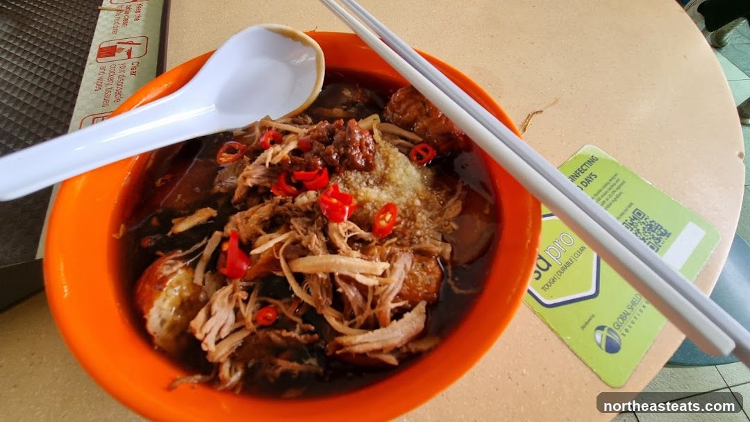 Bowl of noodles with shredded meat and chili