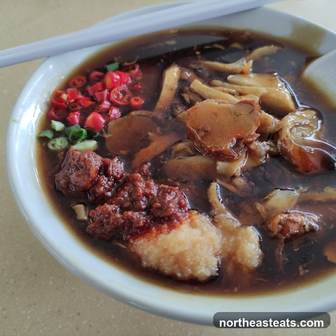 Bowl of Noodles with Chili and Garnish