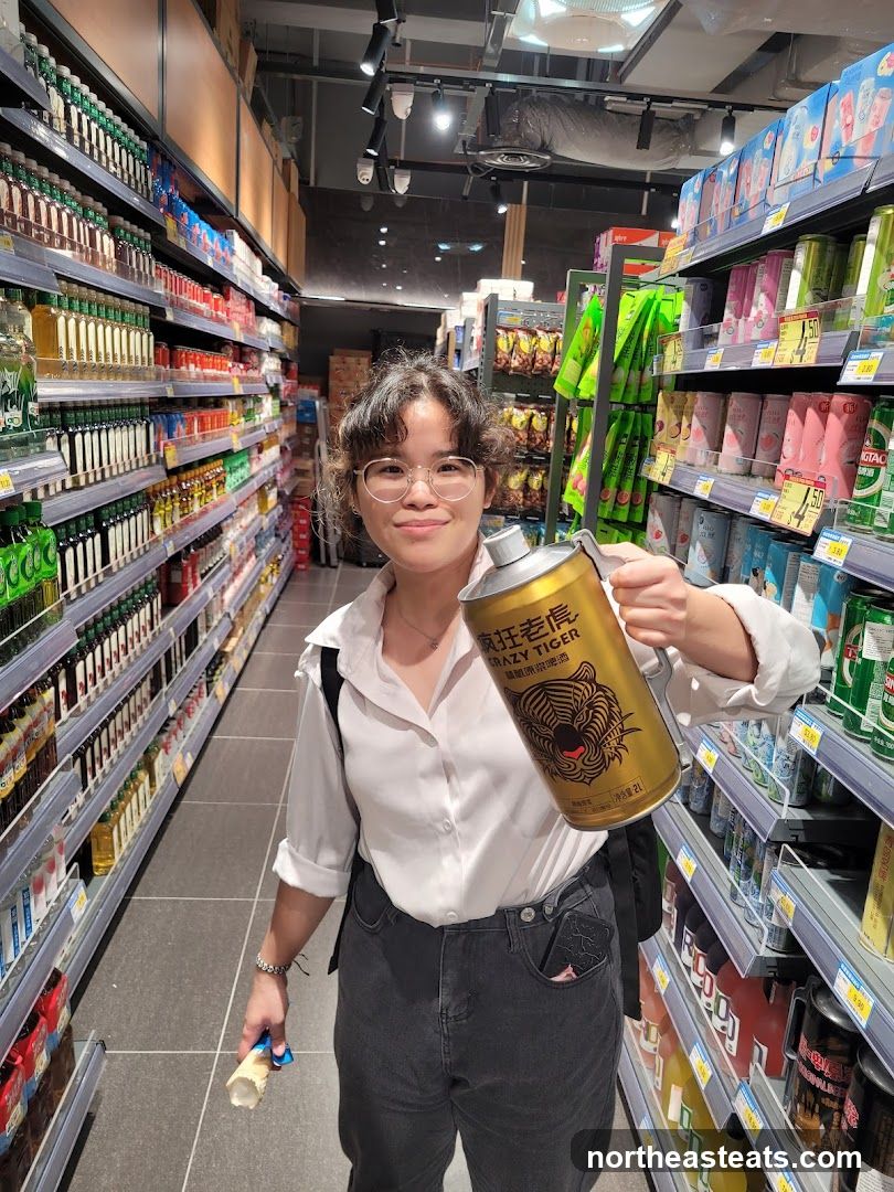 Woman holding a large can in a supermarket aisle