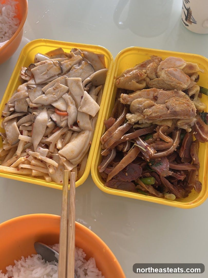 Two containers of food with rice