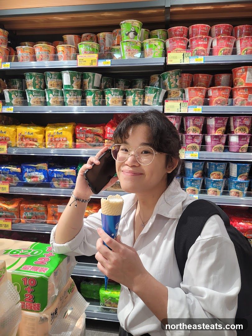 Woman on Phone with Ice Cream in Grocery Store
