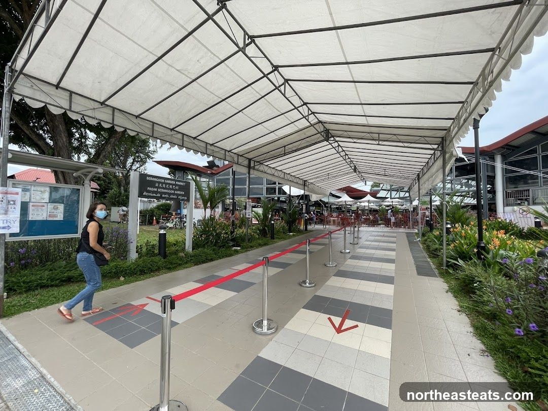 Covered walkway with directional arrows and signage