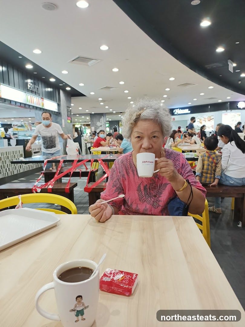 Woman drinking coffee at a food court
