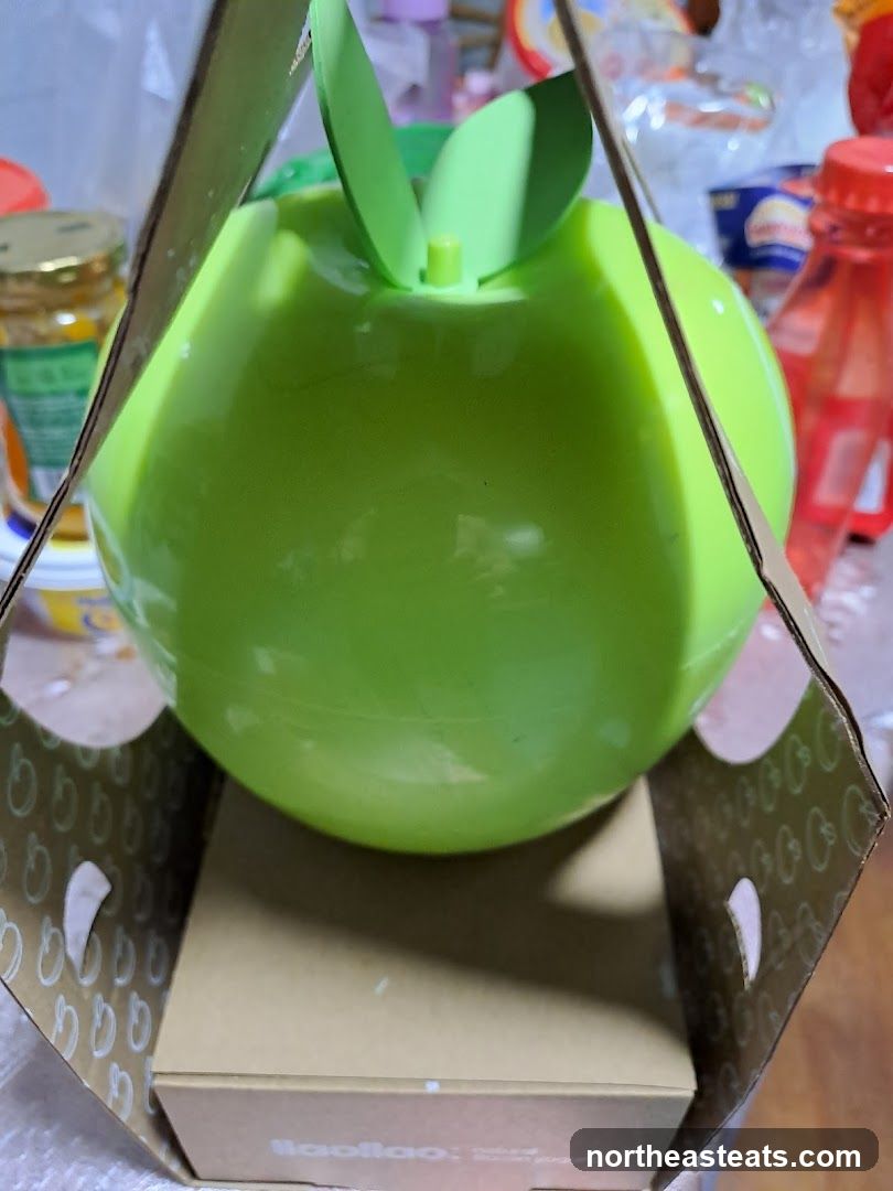 Apple-shaped container with packaging