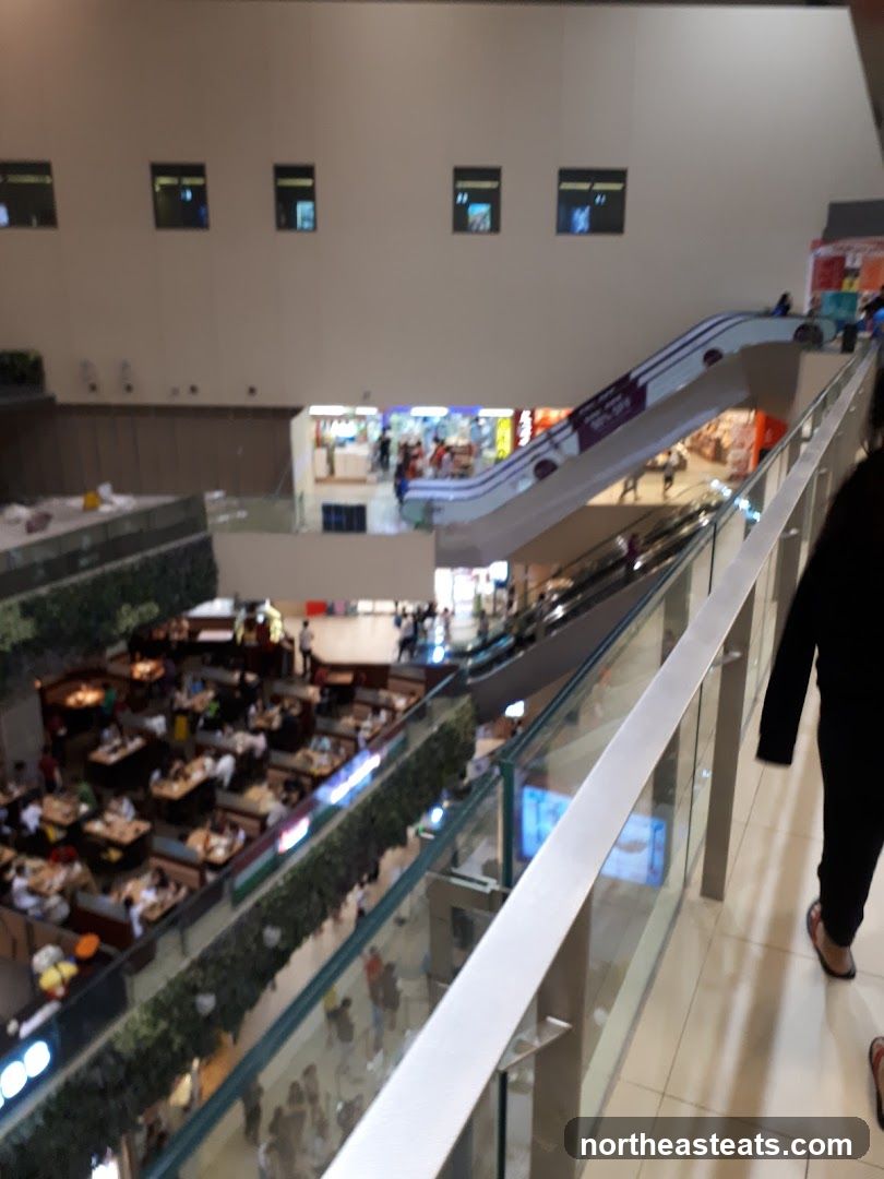 Mall Interior with Escalators and Dining Area
