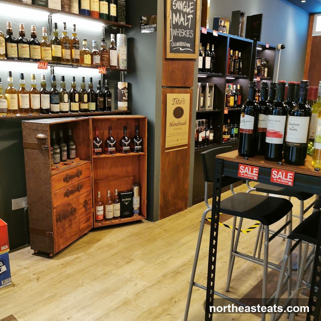 Liquor store interior with shelves of bottles and a display cabinet