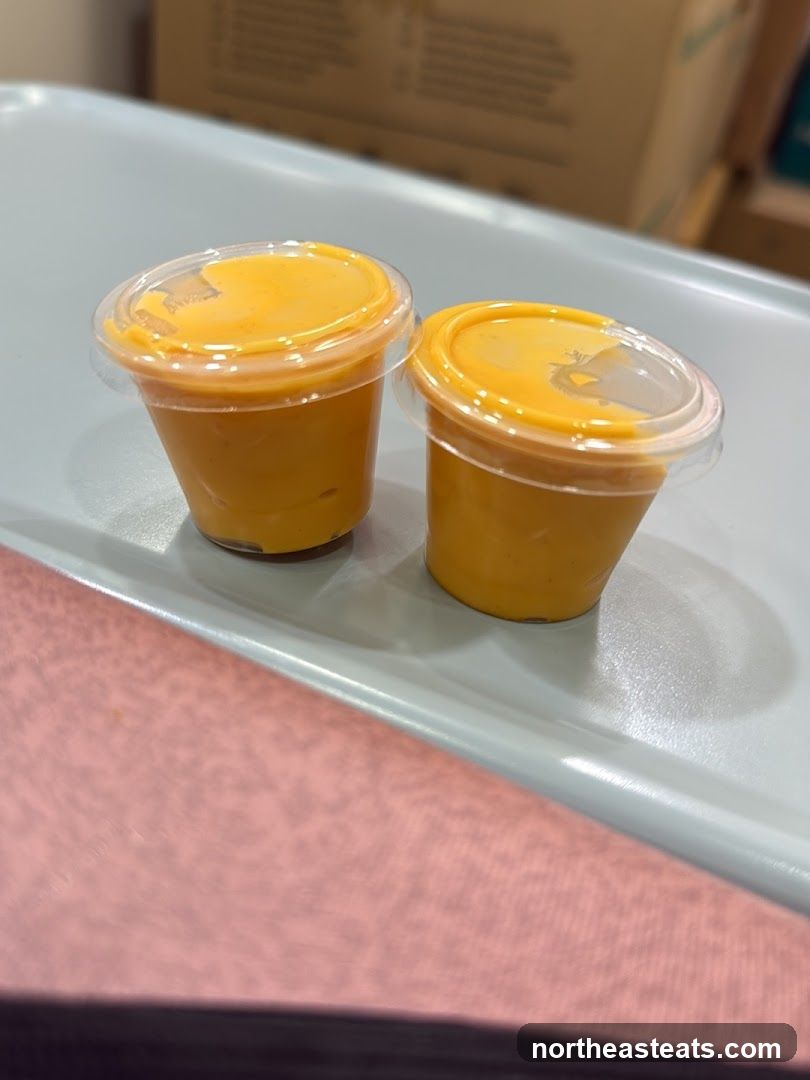 Two small cups of orange sauce