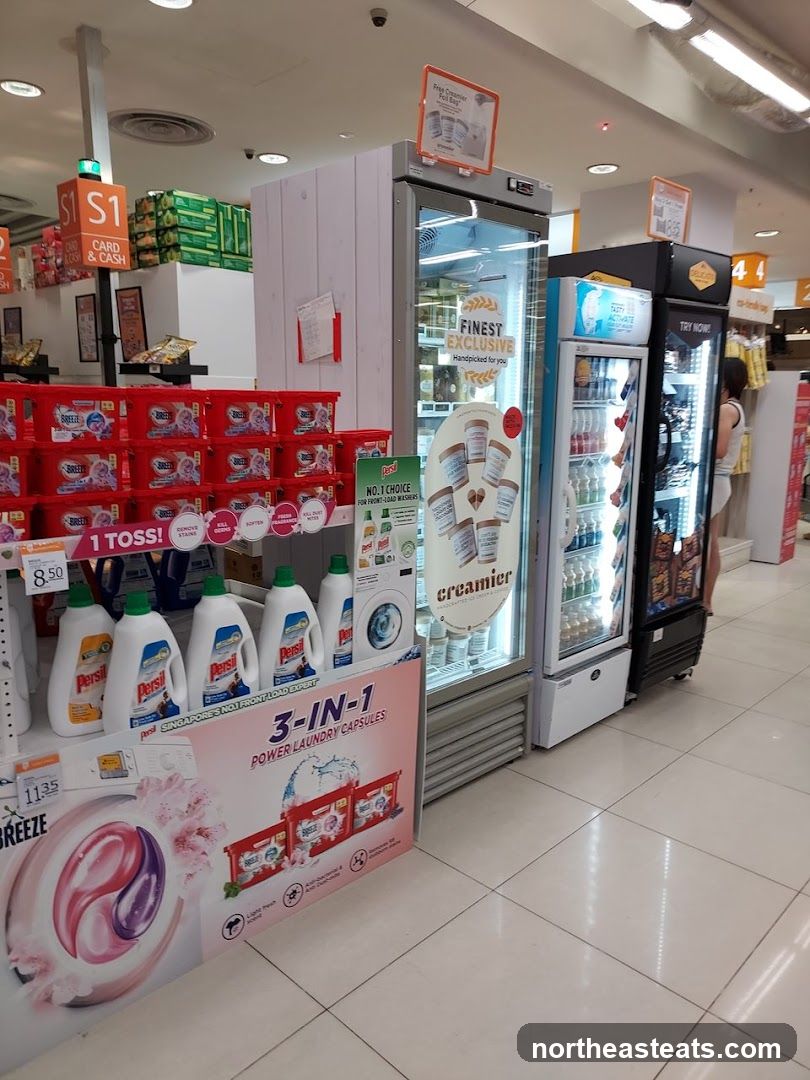 Supermarket aisle with cleaning products and refrigerated display cases