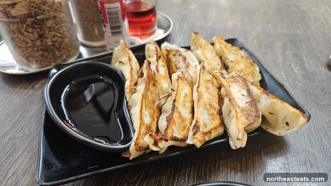 Pan-fried dumplings with dipping sauce