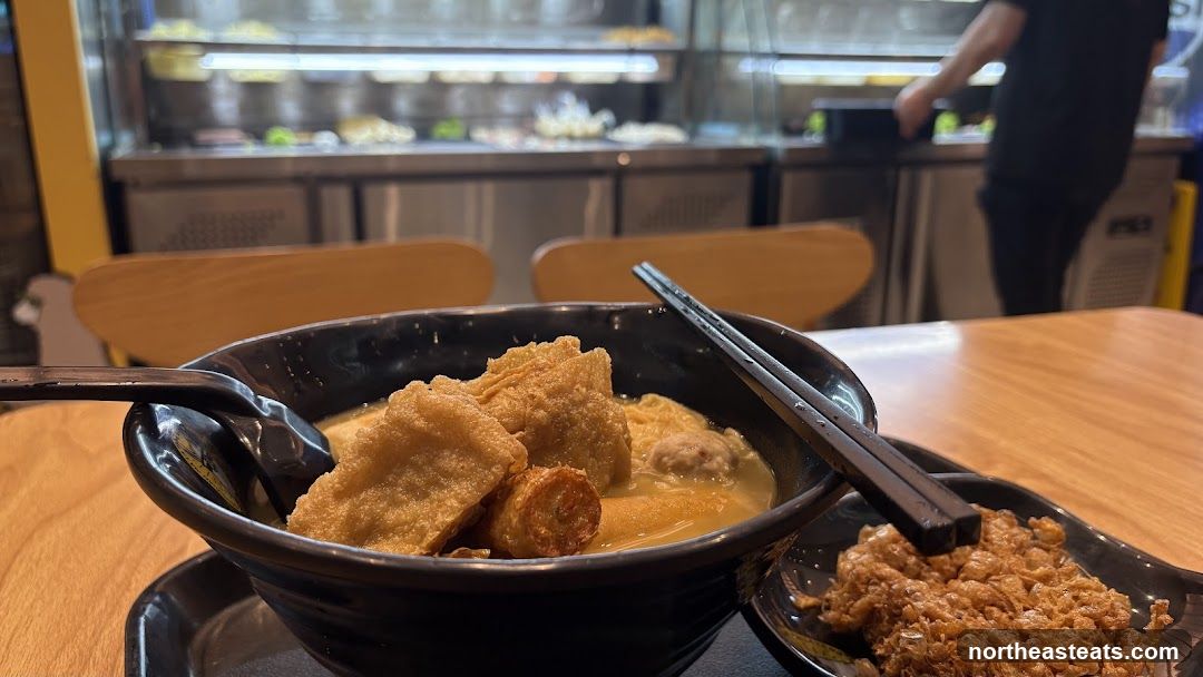 Bowl of noodles with fried toppings