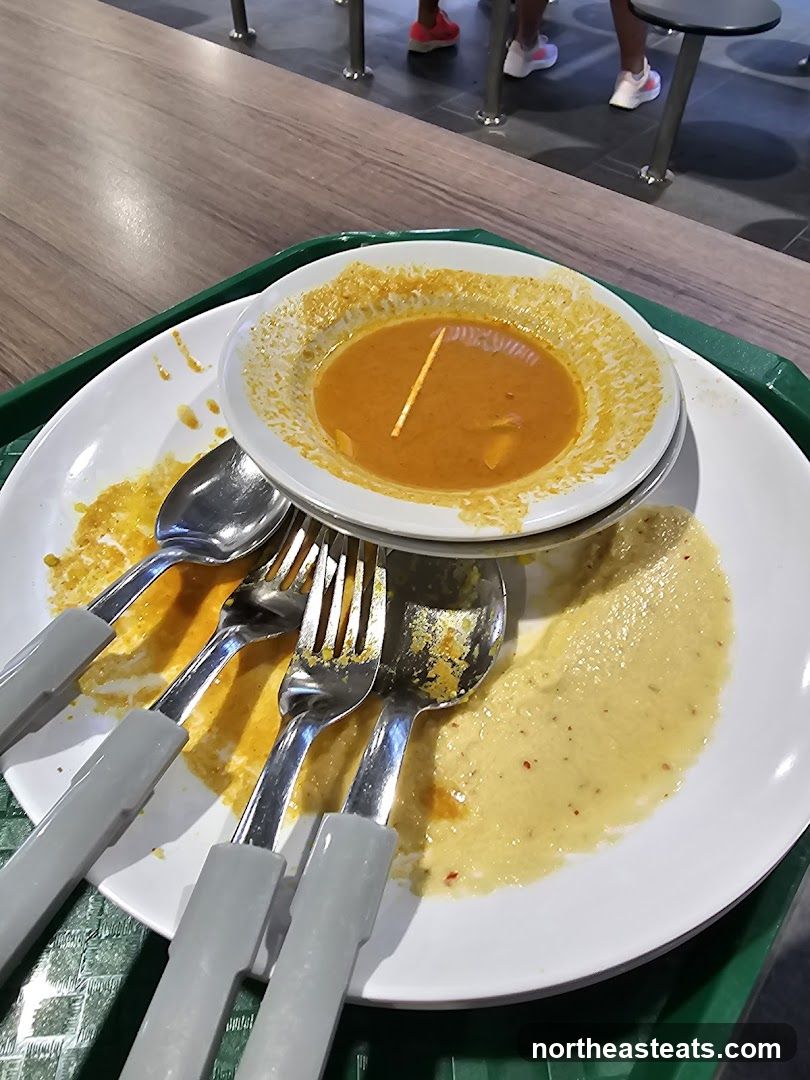 Messy Plate with Curry and Utensils