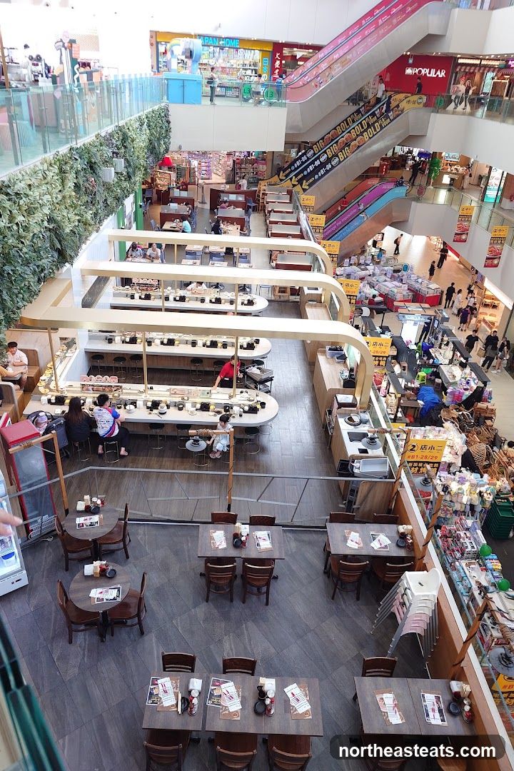Busy shopping mall interior with dining areas
