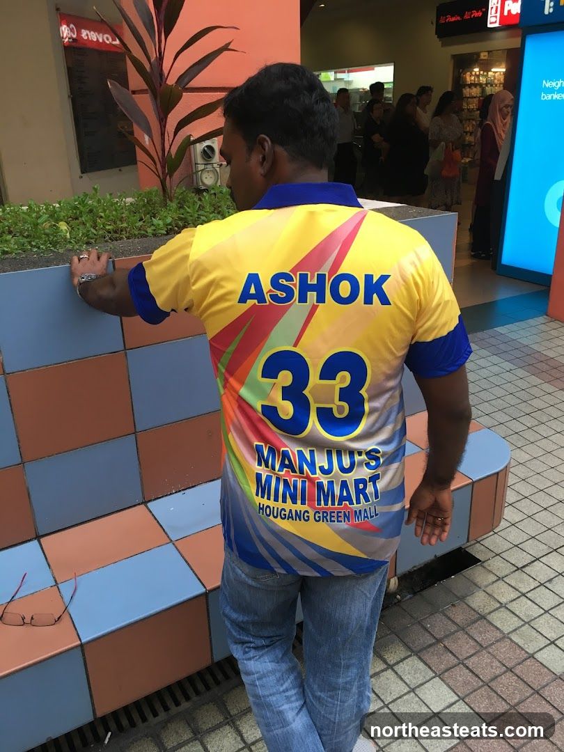 Man wearing a yellow shirt with store name
