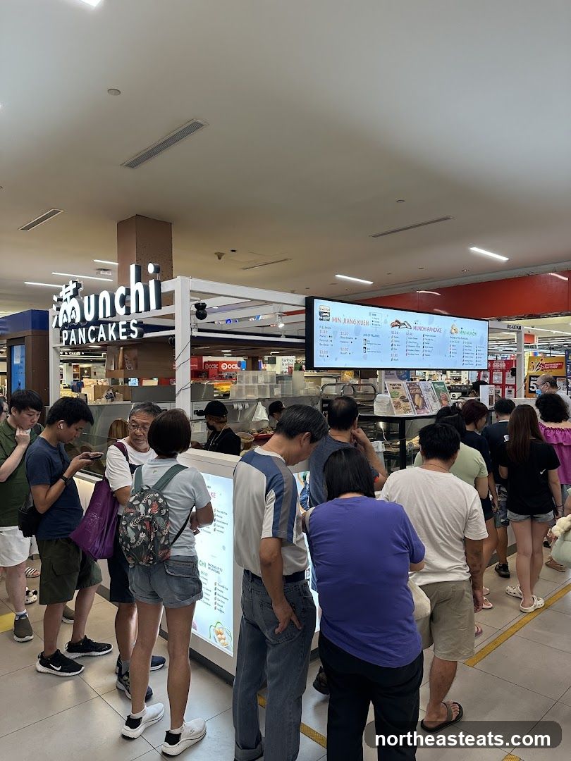 People queuing at a food stall