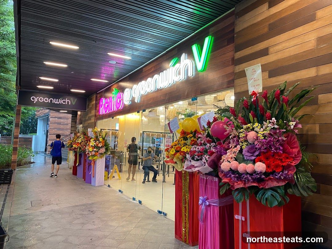 The exterior of a shop with a wooden facade. The shop's name,