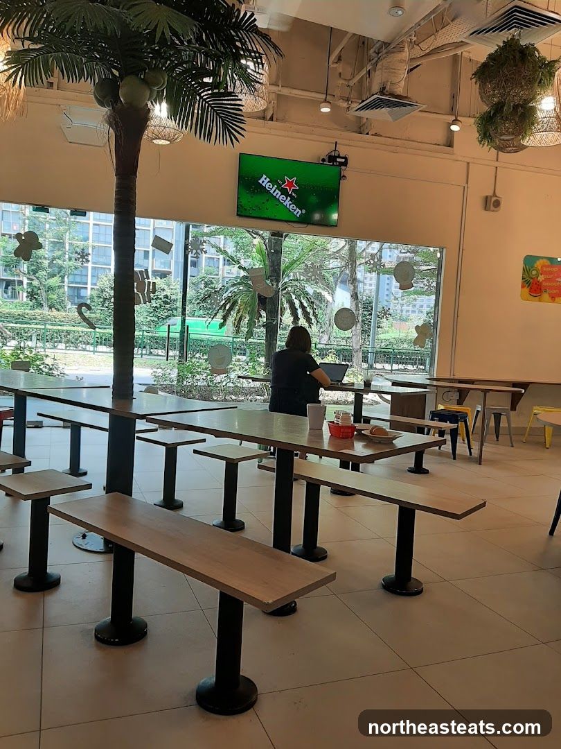 Indoor seating area with a Heineken advertisement