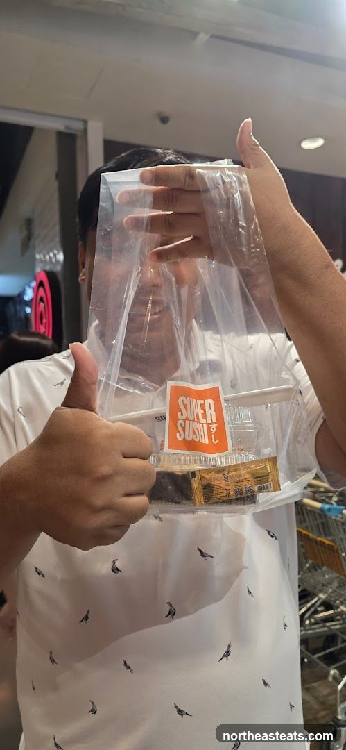 Person holding sushi takeout bag