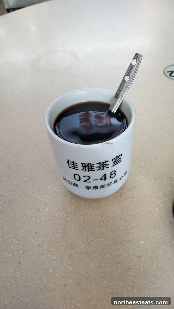 Cup of Dark Liquid with Spoon