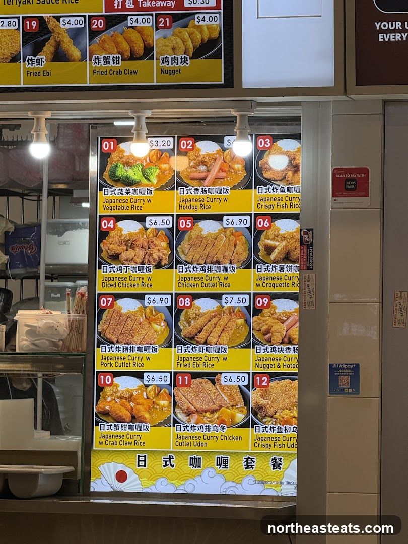 A menu board displaying various Japanese curry rice and udon dishes with prices.