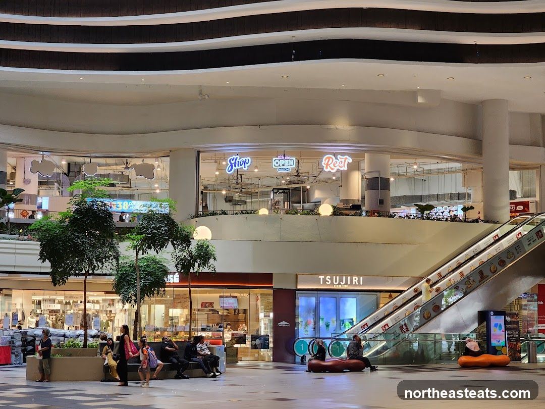 Indoor shopping mall with escalators and shops