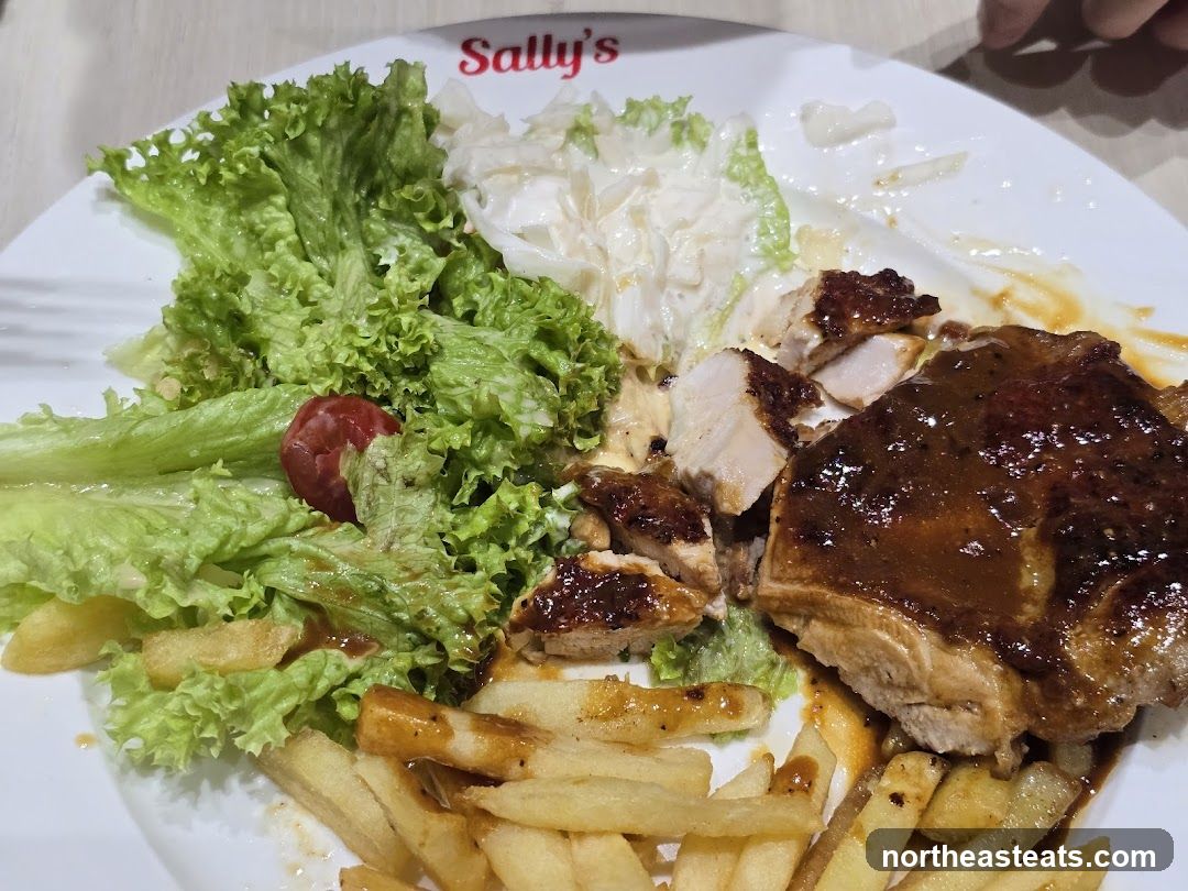 Chicken dish with fries and salad