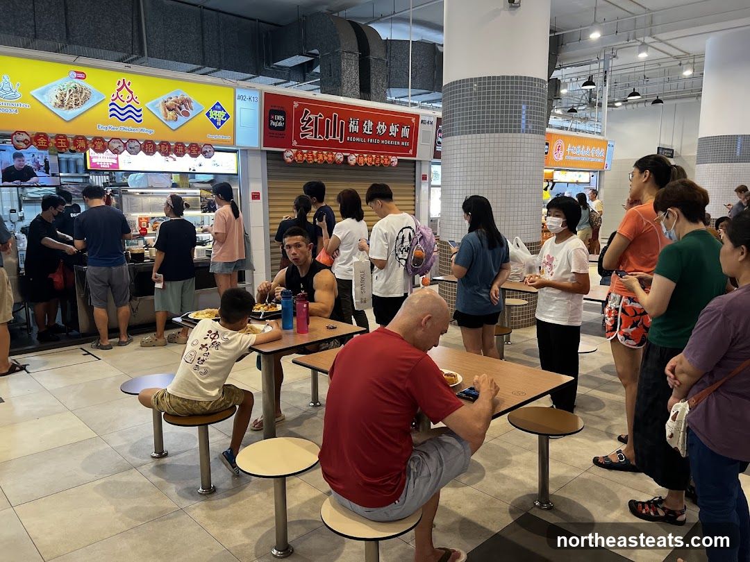 Food court with people eating and queuing