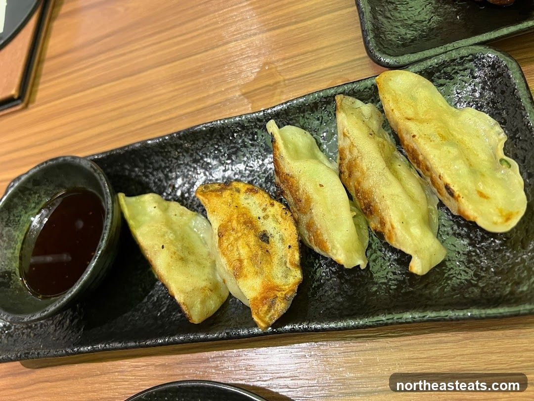 Pan-fried dumplings with dipping sauce