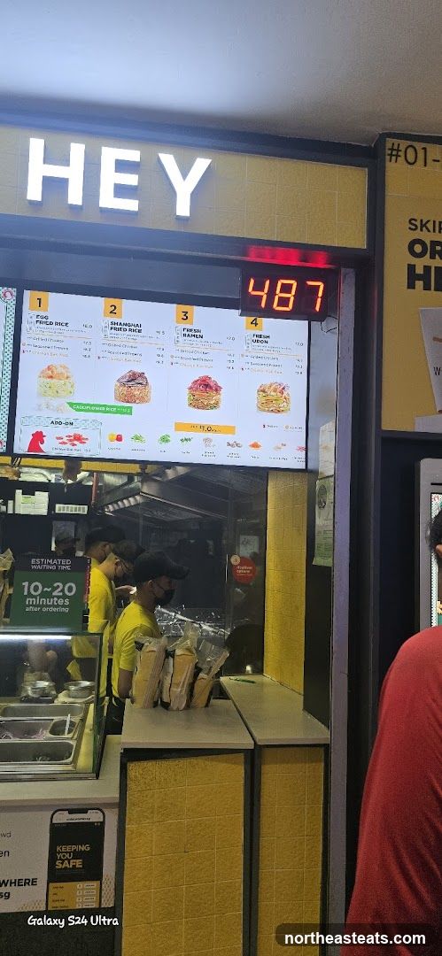 Food stall with menu and staff