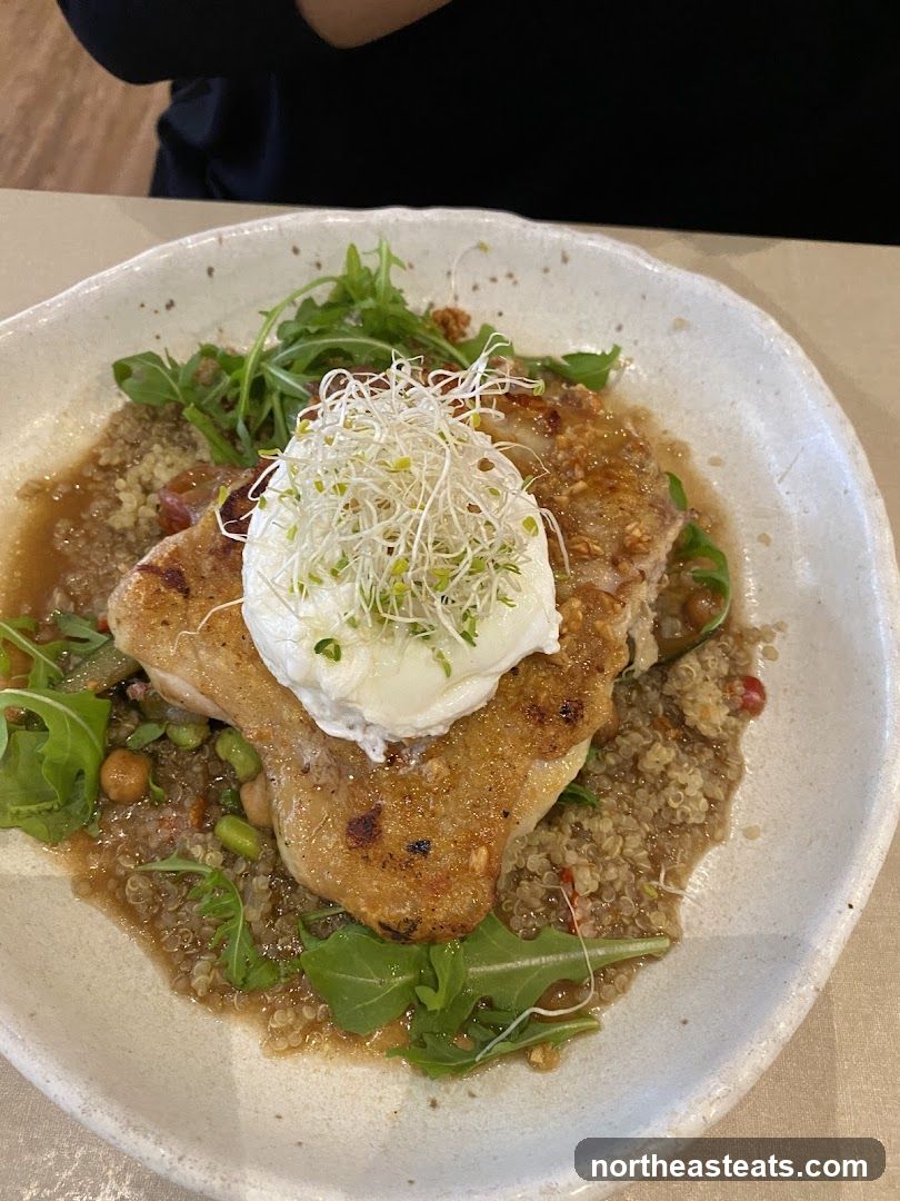 Chicken dish with poached egg and sprouts
