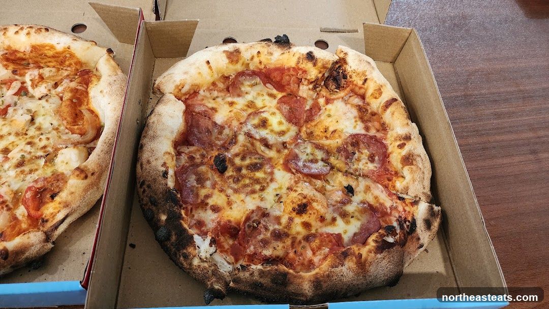 Two Pizzas in Cardboard Boxes