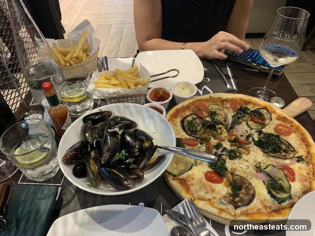 Table with Pizza, Mussels, and Fries