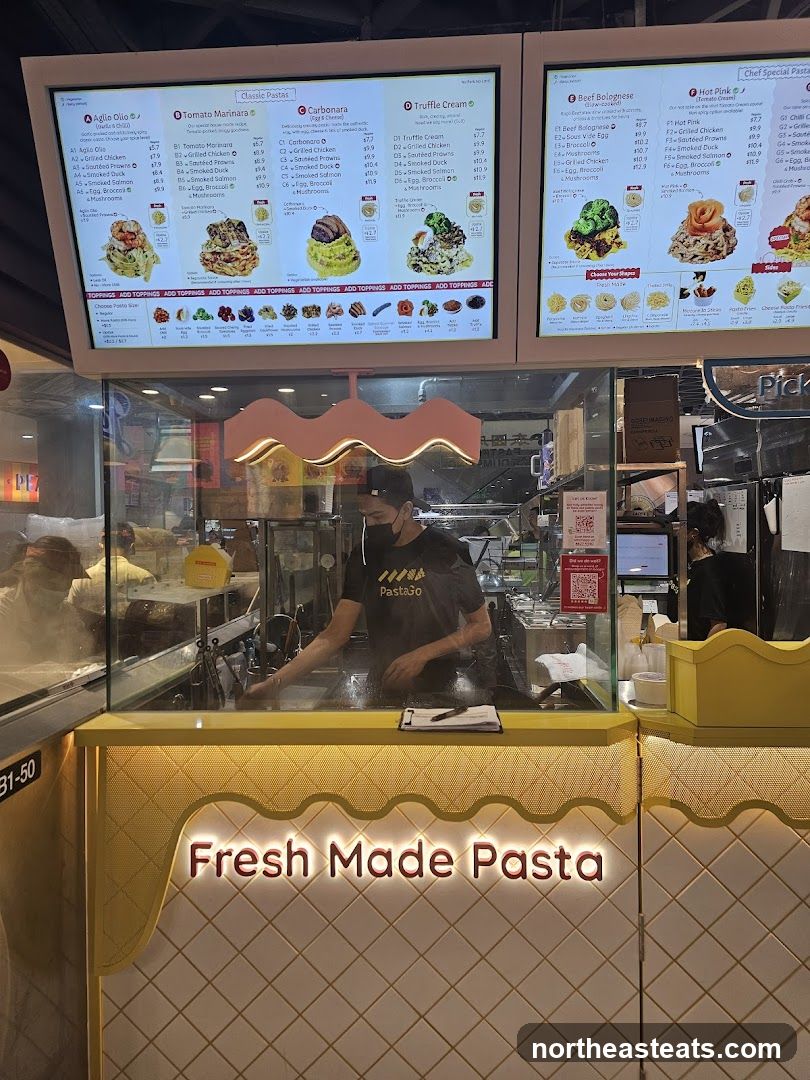A menu board displaying various pasta dishes with options for customization.