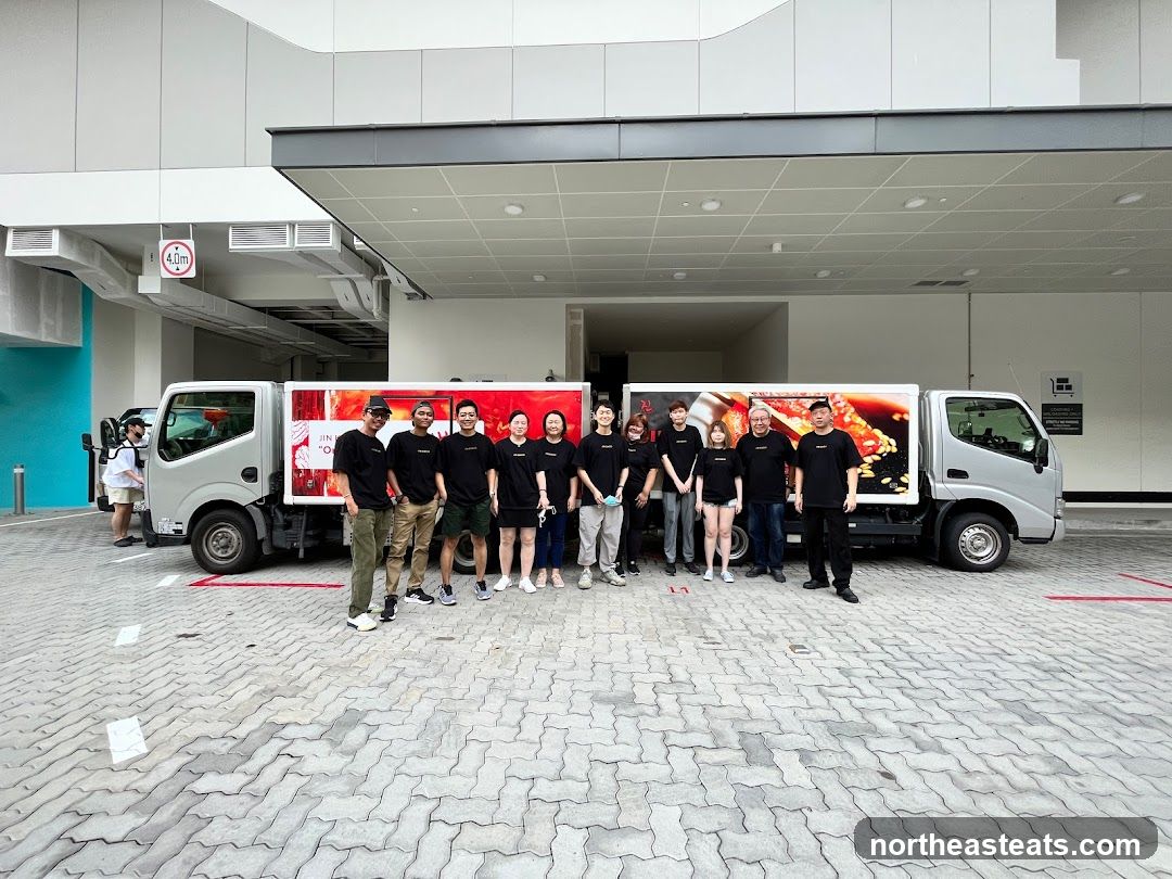Team Posing with Branded Trucks