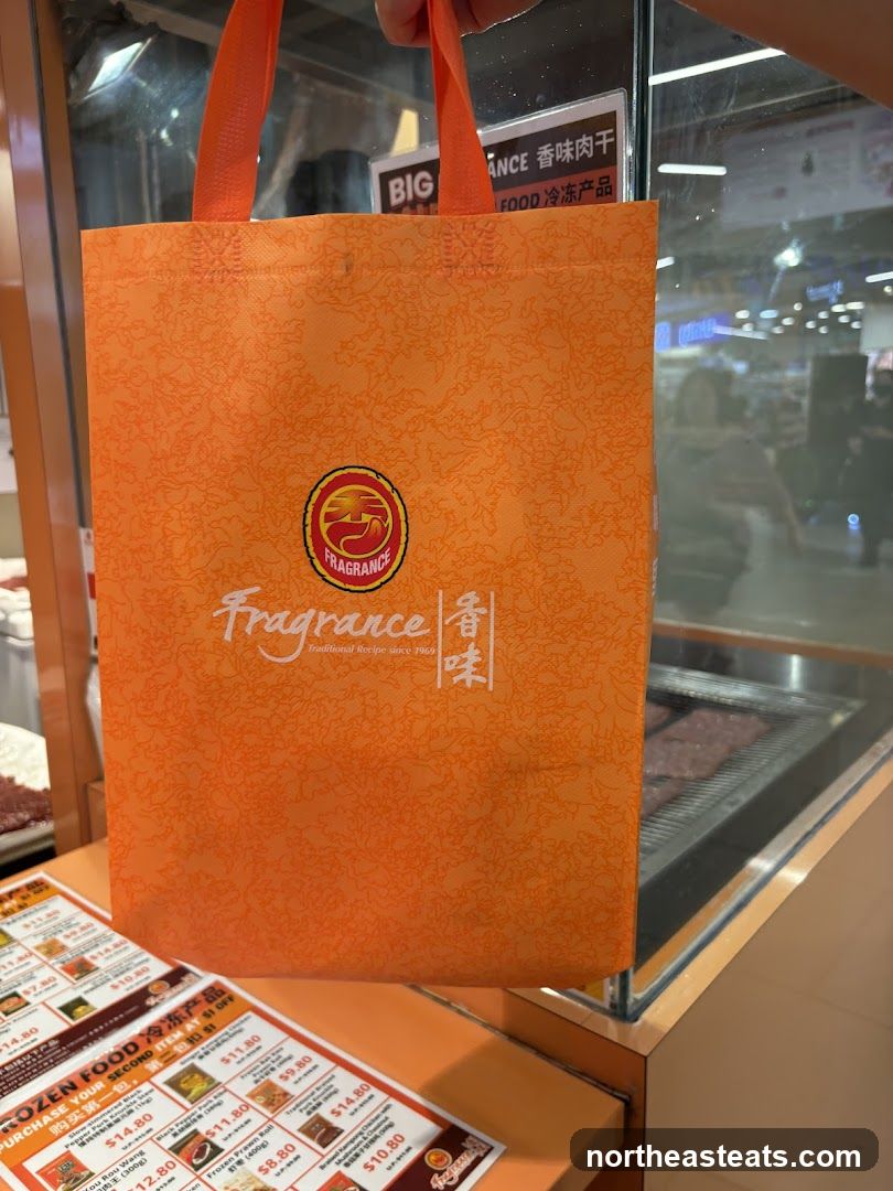 Orange tote bag with "Fragrance" logo